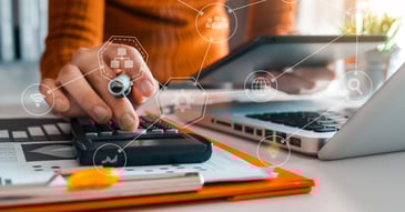 accountant organising payments on a laptop with calculator