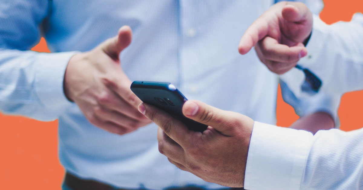 sms payment reminder being received on a phone person pointing to phone