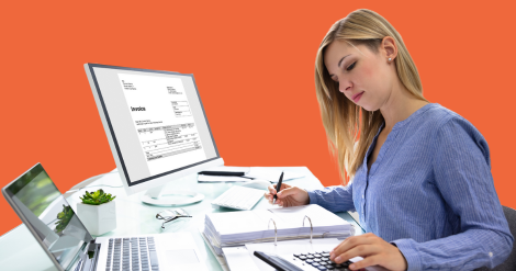 accountant working using a calculator, pen, laptop, computer at her desk