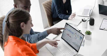 people pointing at computer on topic of payment remittance in b2b payments