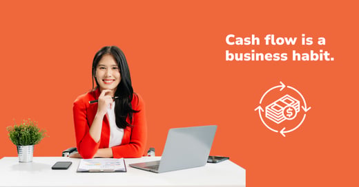 Businesswoman at a desk with a laptop and paperwork
