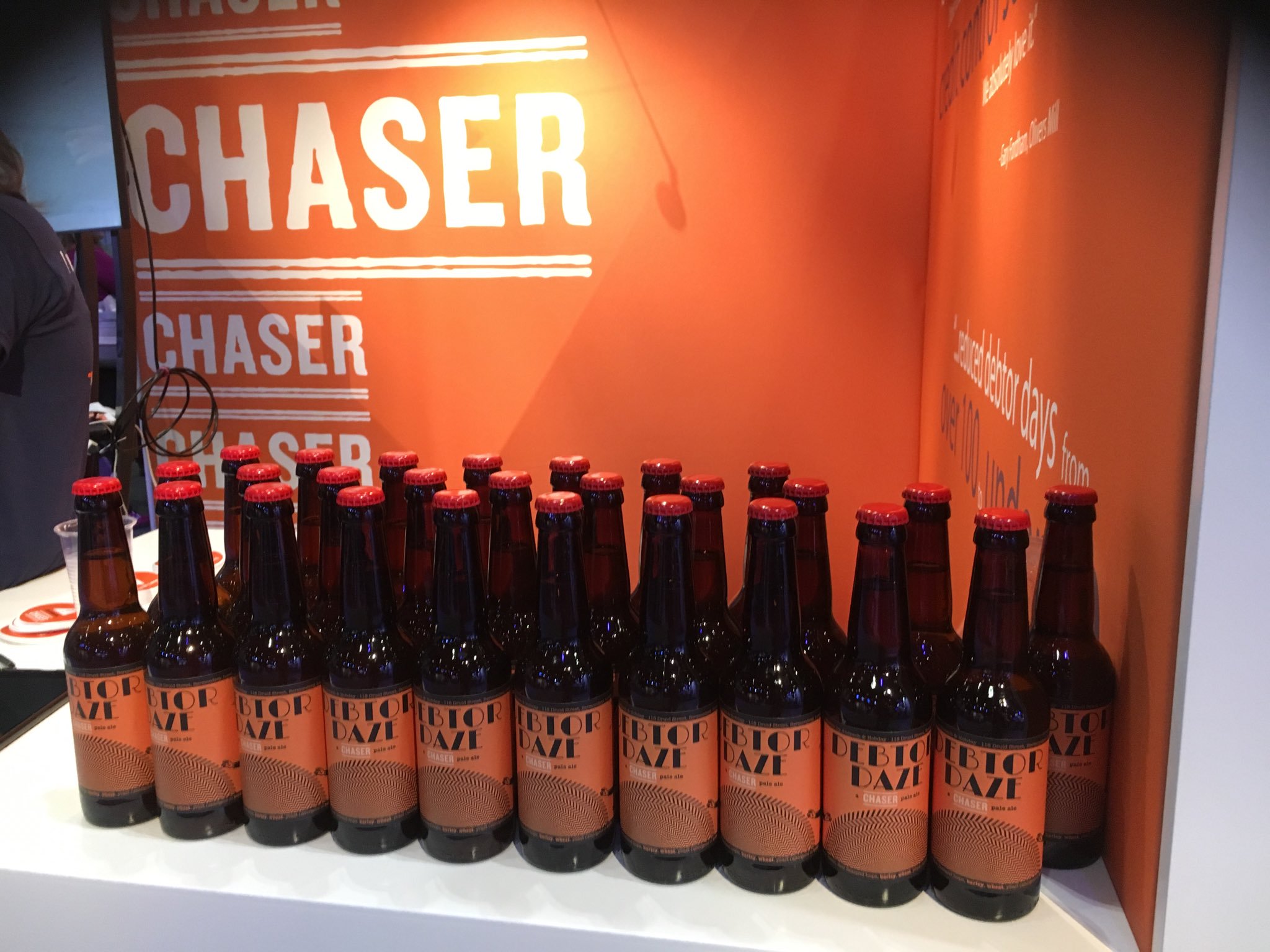 Many bottles of Chaser's Debtor Daze ale lined up along their Xerocon London 2017 stand